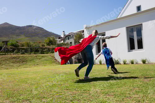Preview: Mother and son in superhero costume playing in the backyard