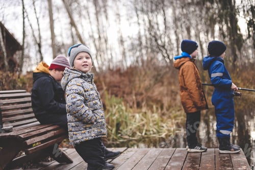 Preview: Diverse group of people, boys of different ages friends fishing on lake in countryside on fall day N