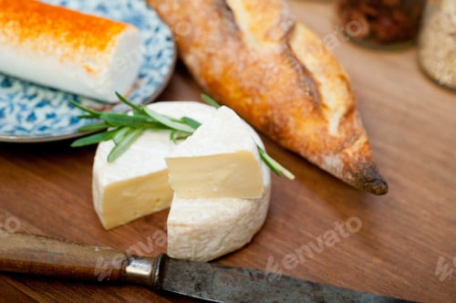Preview: French cheese and fresh baguette on a wood cutter