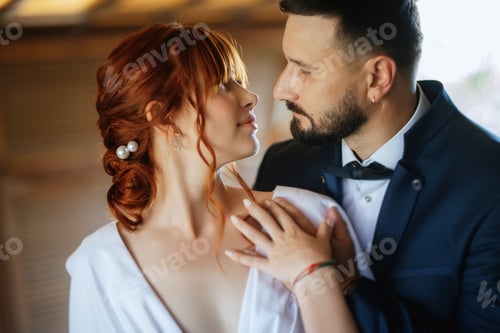 Preview: bride in a white dress with a bouquet and the groom in a blue suit