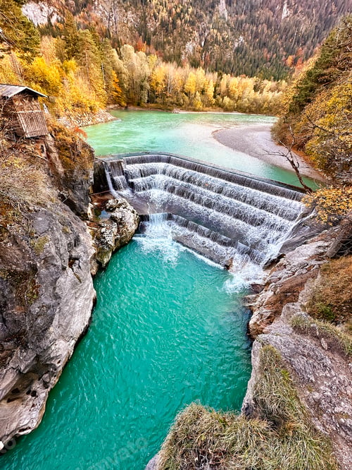Preview: Aerial View To Blue Waterfall Water Surrounded By Autumn Colorful Trees On Mountain