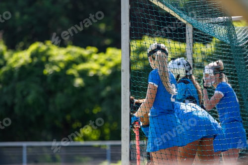 Preview: Field hockey players in blue uniforms focus on defending the goal