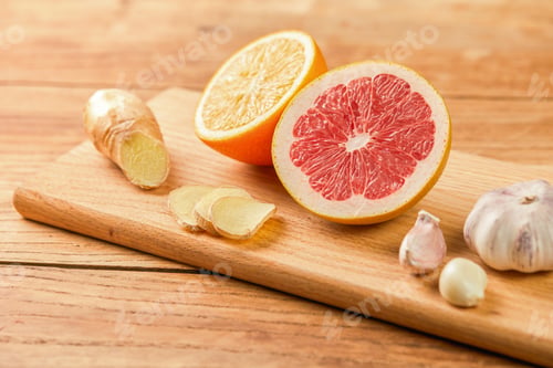 Preview: Set of healthy food to boost immune system - grapefruit, orange, garlic and ginger on chopping board