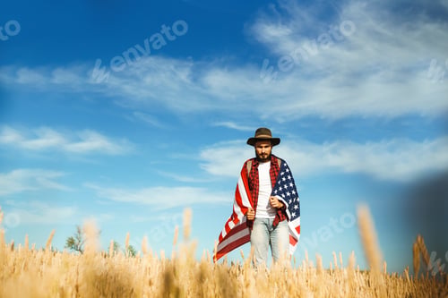 Preview: 4th of July. American Flag.Patriotic holiday. Traveler with flag of America. Beautiful sunset light