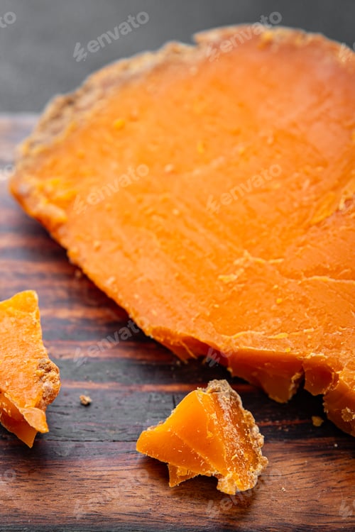 Preview: Aged cheese Mimolette or cheddar fresh tasty food dish delicious gourmet food background on the tabl