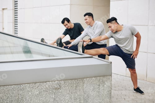 Preview: Young Vietnamese men stretching legs