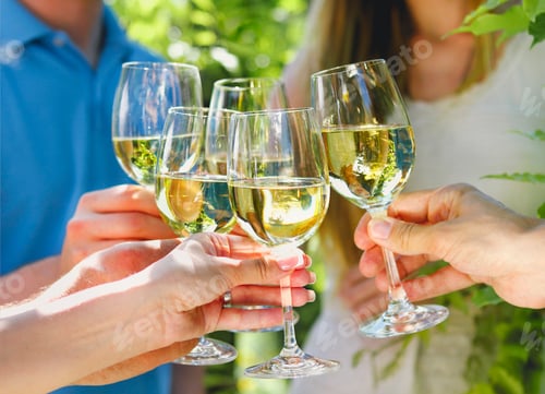 Preview: Celebration. People holding glasses of white wine making a toast.