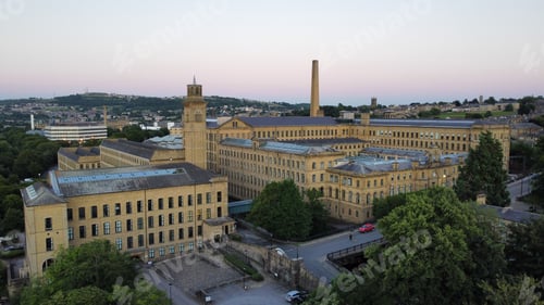 Preview: Aerial shot of cityscape Saltaire with Salts Mill building in daylight