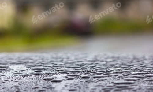 Preview: Large drops of rain on the roof of the car, close-up