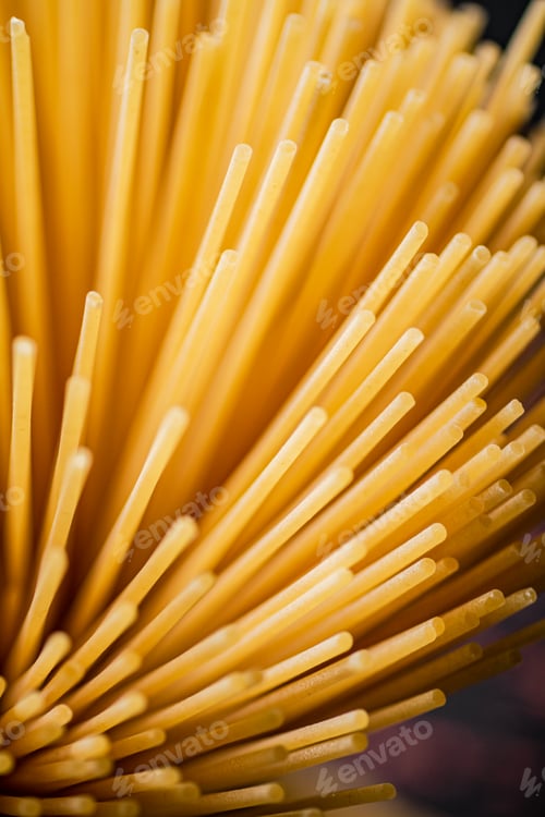 Preview: Not boiled spaghetti dry on a black background.