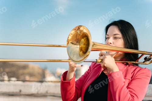 Preview: Trombonist playing on the roof of the building