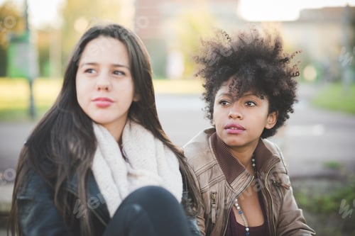 Preview: two multiethnic beautiful young woman black and white having fun