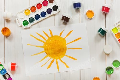 Preview: Drawing sun on the desktop, a top view. Education and art, creative concept.