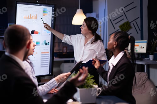 Preview: Multi ethnic businesspeople brainstorming company ideas checking graphs statistics