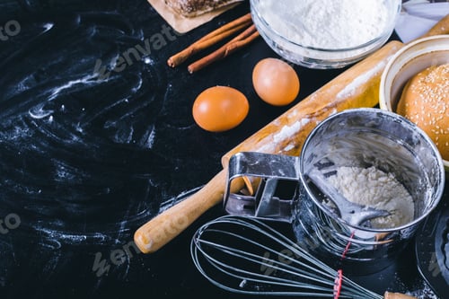 Preview: Ingredients and utensil for baking on the black board, top view