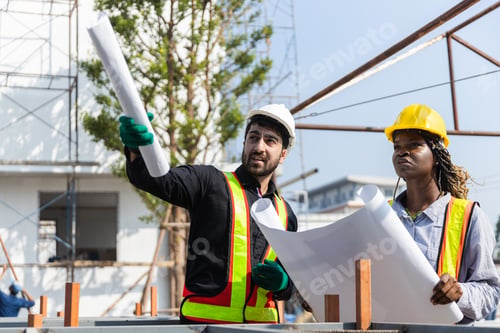 Preview: Construction civil engineer man and woman African American checking quality of work in construction