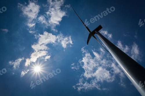 Preview: Wind Turbine with path on green field with blue sky