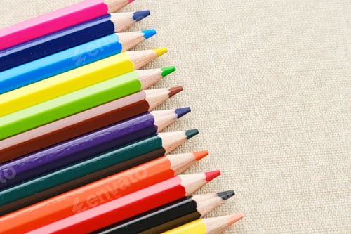 Preview: Colorful sharpened pencils are lined up on the table. Flat lay