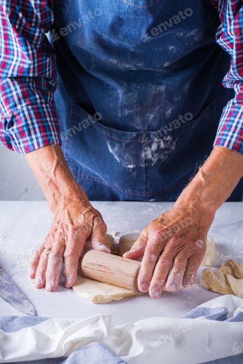 Preview: Baking at home concept. Senior man hands cooking, making dough