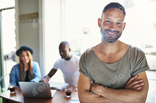 Preview: Young male posing with co-workers on background