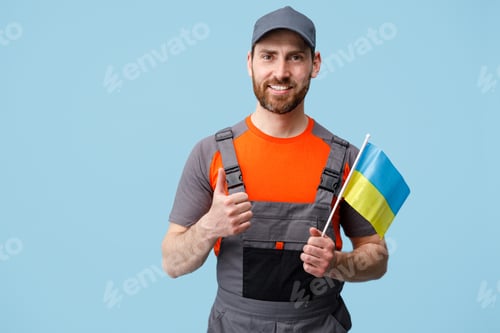 Preview: Smiling Worker employee man in uniform holding ukrainian national flag in hand