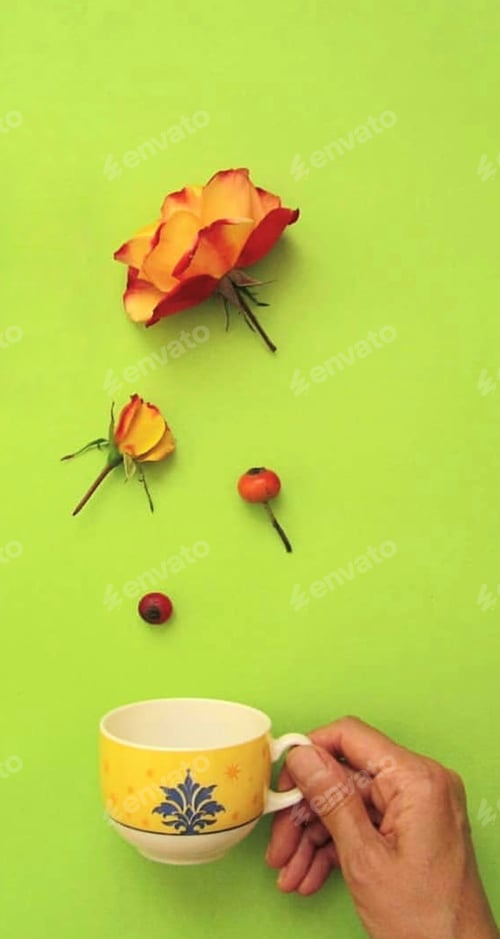 Preview: Yellow Tea Cup with Flowers on Green Background
