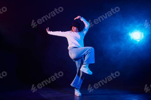 Preview: a girl in light clothes dances on a neon background in smoke, modern dance