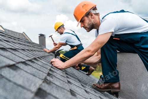 Preview: selective focus of handsome handyman repairing roof with coworker