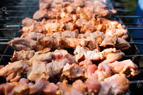Preview: The meat is grilled on charcoal, close-up. Cooking barbecue outdoors