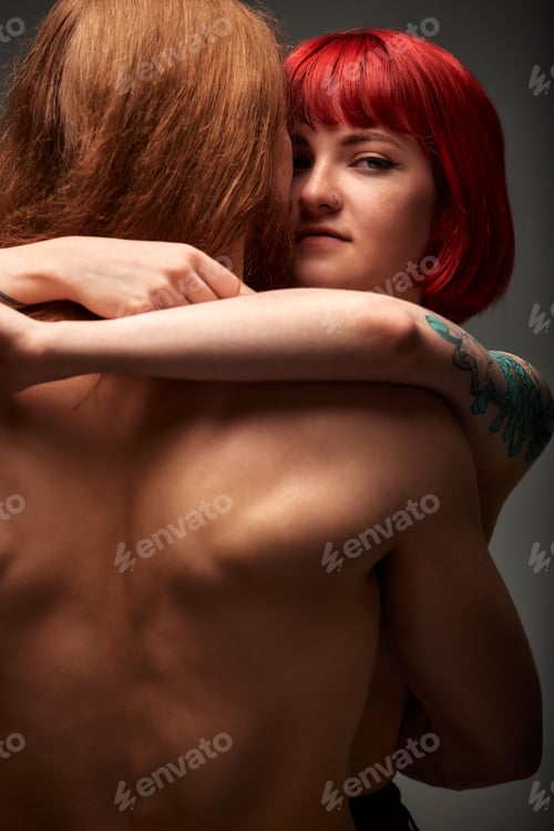 Preview: Sexy passionate couple in love in the studio. The woman's arms embrace a handsome half-naked man