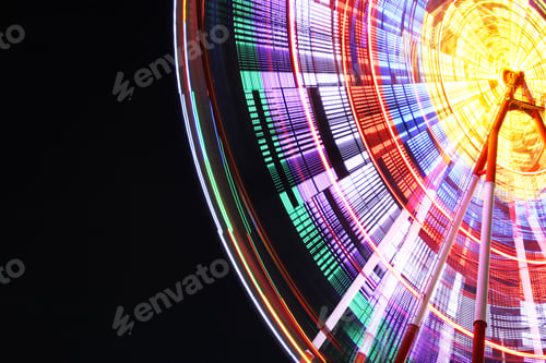 Preview: Beautiful glowing Ferris wheel against dark sky, low angle view. Space for text