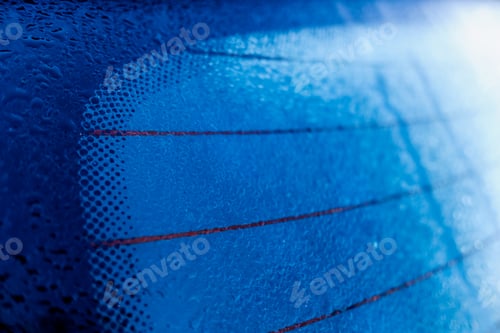 Preview: Heating anti-fog stripes on the rear windshield of a car with dew drops.