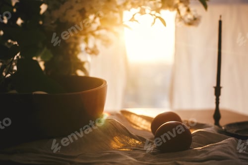 Preview: Natural Easter eggs and vintage candle in sunset warm light