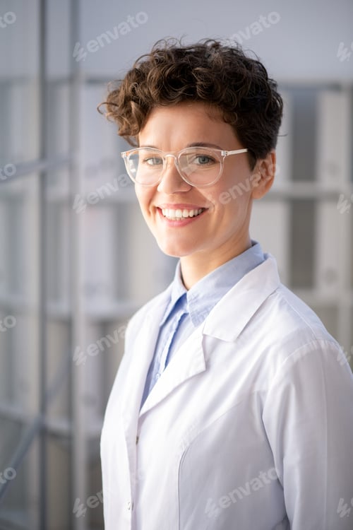 Preview: Young successful female scientist standing in front of camera in scientific lab