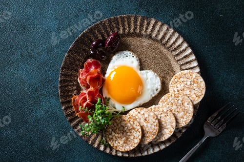 Preview: Breakfast on Valentine's Day - fried eggs in the shape of a heart and olives. Healthy breakfast