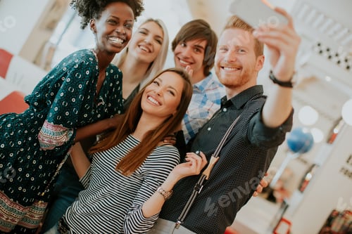 Preview: Group of young people taking selfie with mobile phone