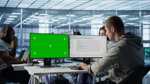 Preview: IT expert supervising data center supercomputers using mockup computer monitor