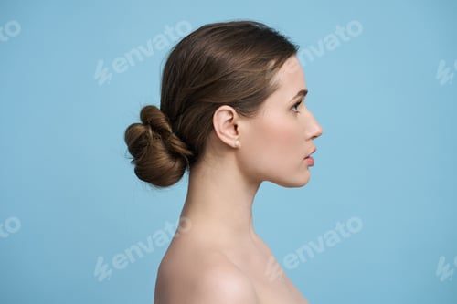 Preview: Side Profile of Woman with Brown Hair in Bun