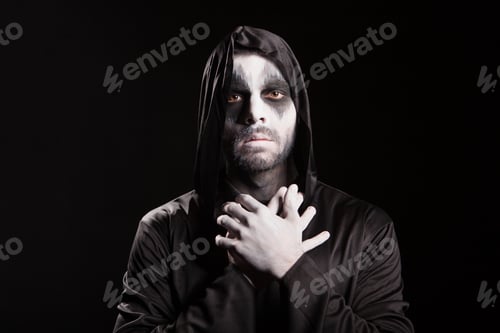 Preview: Spooky angel of death over black background with a hood