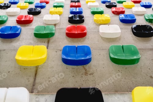 Preview: Brightly colored plastic seats without anyone sitting in a sports hall for the public.