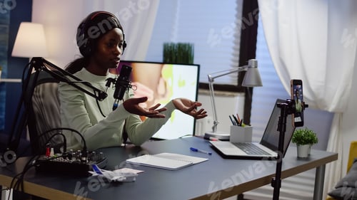 Preview: African influencer wearing headphones checking sound recording new podcast