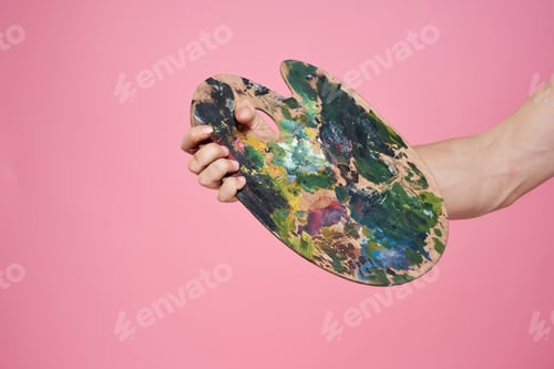 Preview: Palette with paints in hand artist drawing pink background occupation