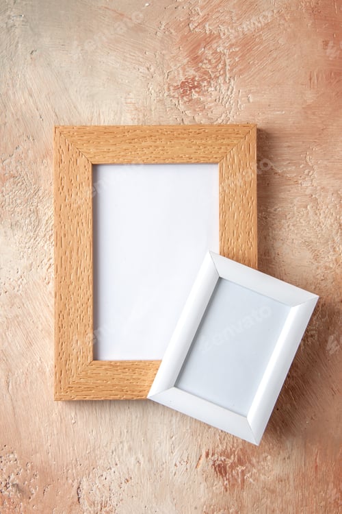 Preview: Vertical view of small and big colorful photo frames hanging on pastel colors wall with free space