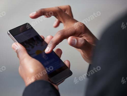 Preview: Checking out the digital world. Shot of an unrecognizable businessman using a phone in the city.