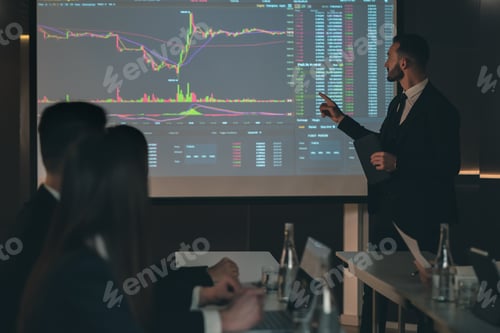 Preview: The man standing near the screen on the business meeting.