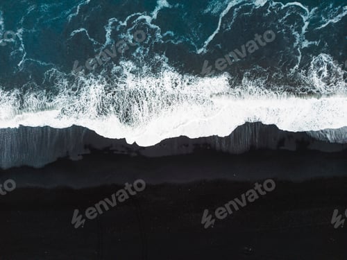Preview: Directly above waves crashing on the black sand beach