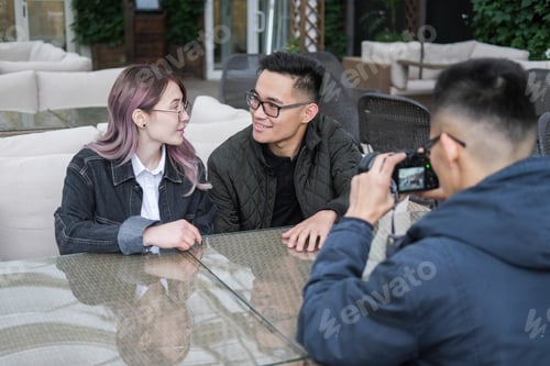 Preview: Three Young Hipsters Sitting In A Cafe And Do Photo.