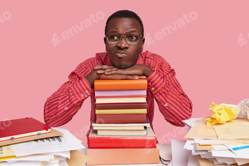 Preview: Bored unhappy African American man has displeased facial exoression, purses lips, has thoughtful exp