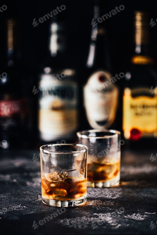 Preview: Whiskey with ice on a dark table