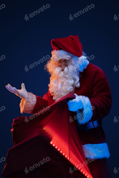 Preview: Amazed santa with big bag against dark background